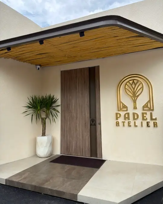 Entrance with the gold Padel Atelier sign