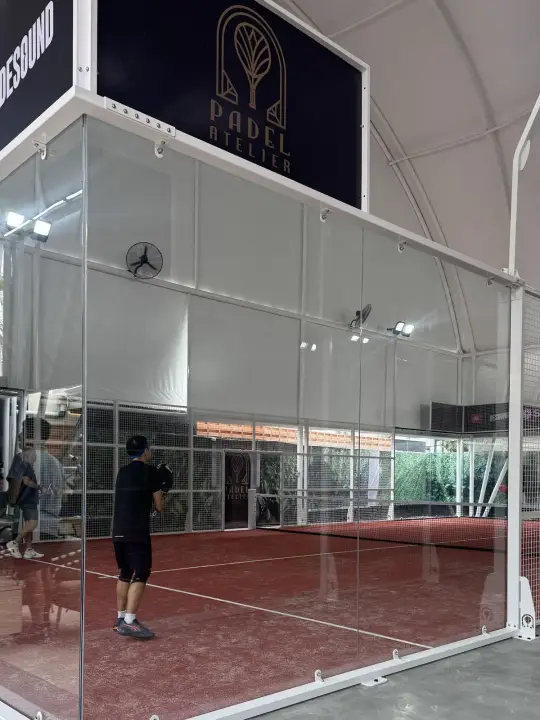 Gold logo inlaid in the floor beside a court