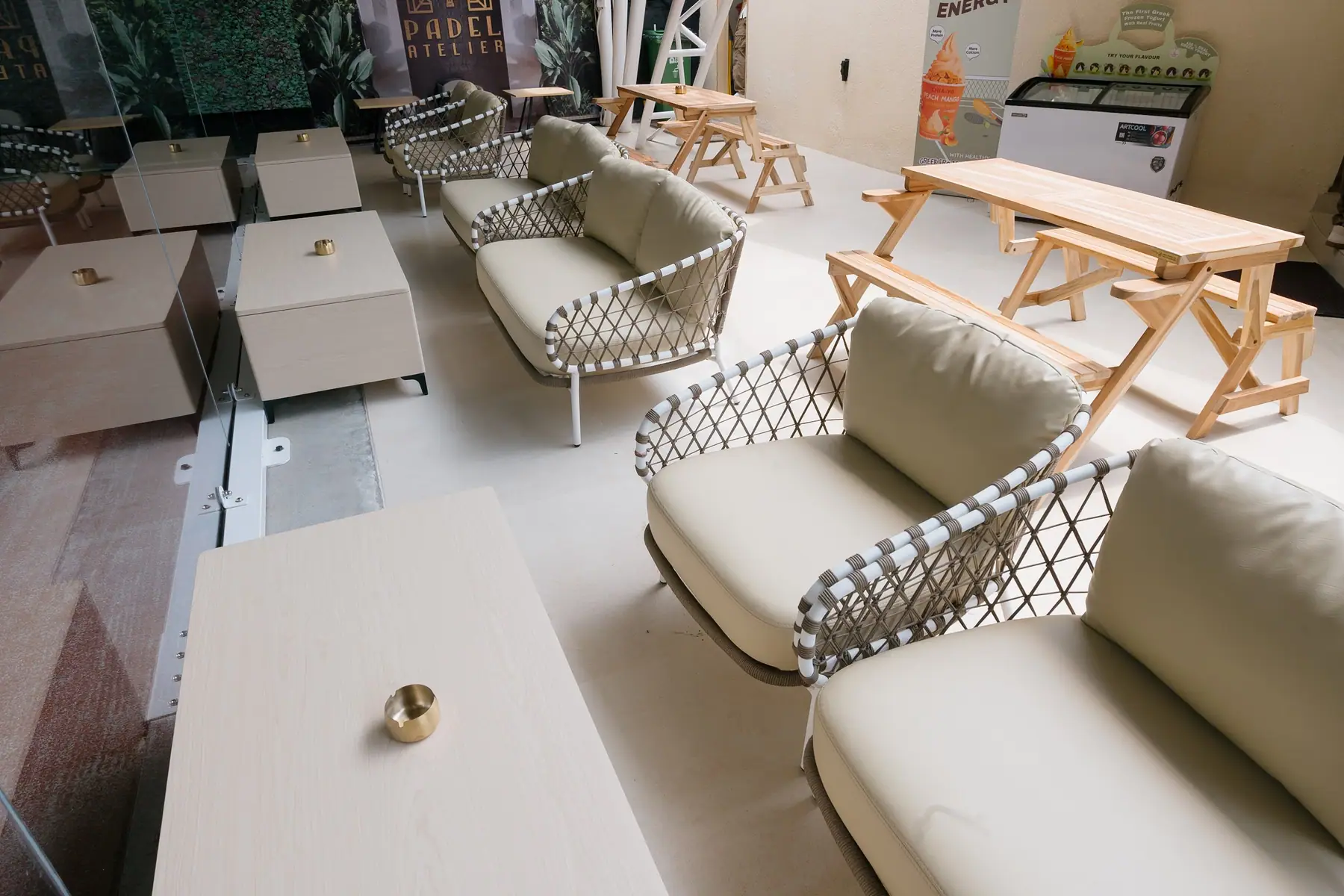 Cream lounge sofas and picnic tables by the courts