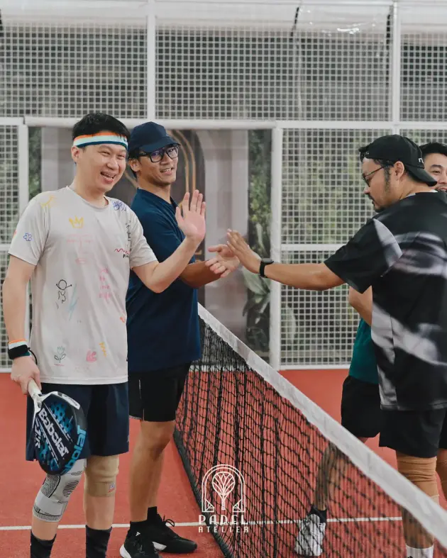 Players high-fiving at the net